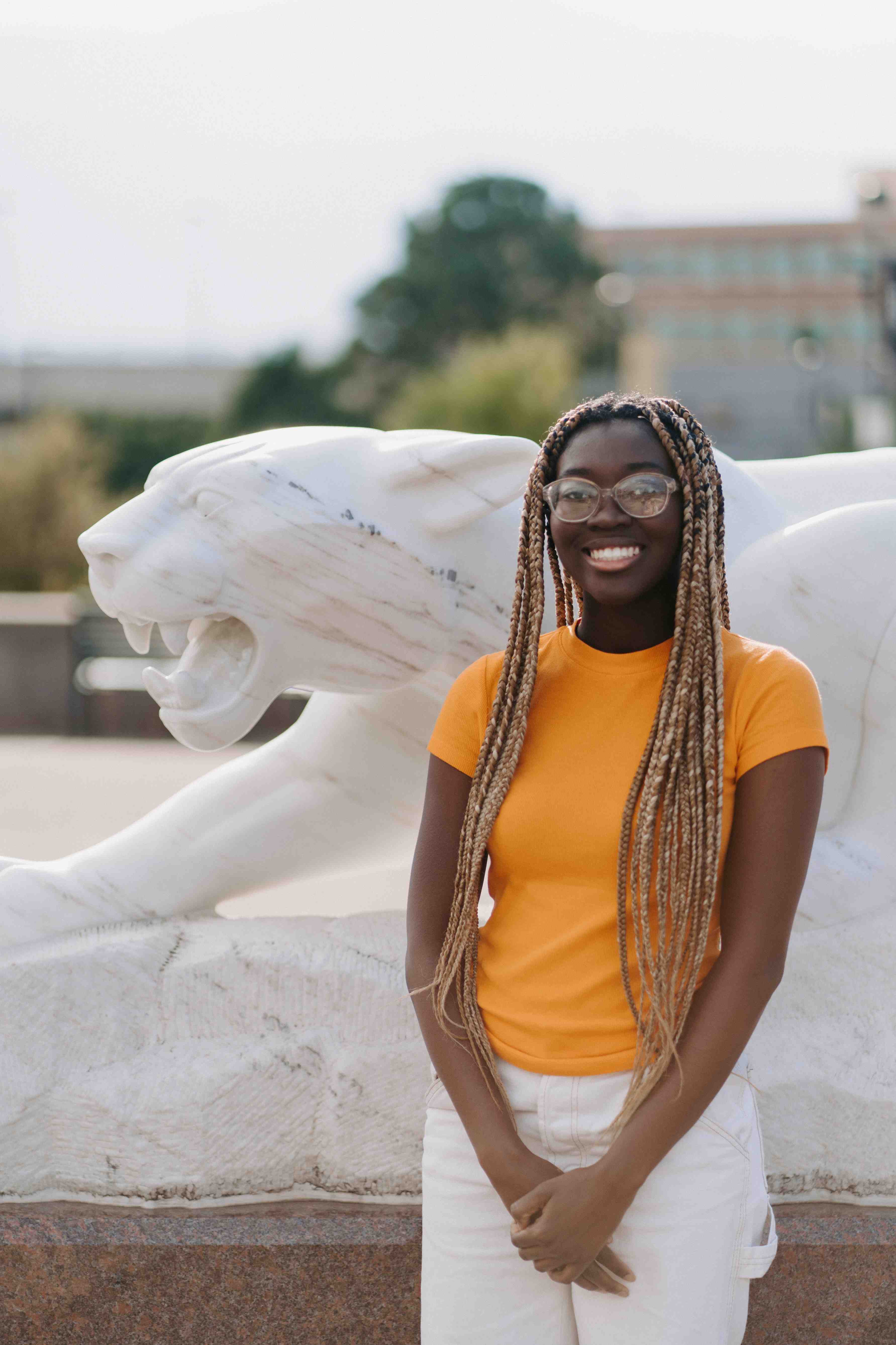 Photo of Emmanuella Appiah in front of the mountain lion statue