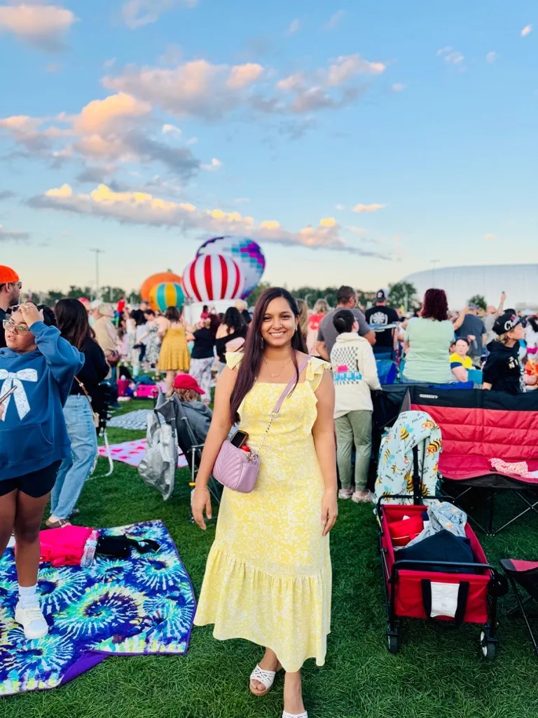 Woman in yellow dress with black hair at festival