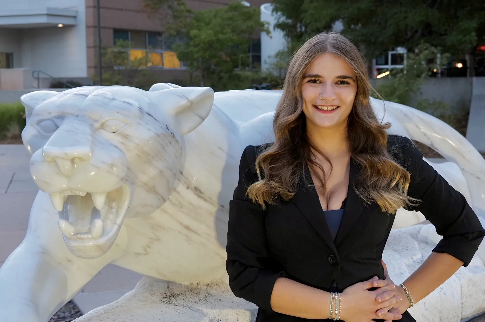 Photo of BreAnna Fraker posing next to a mountain lion statue