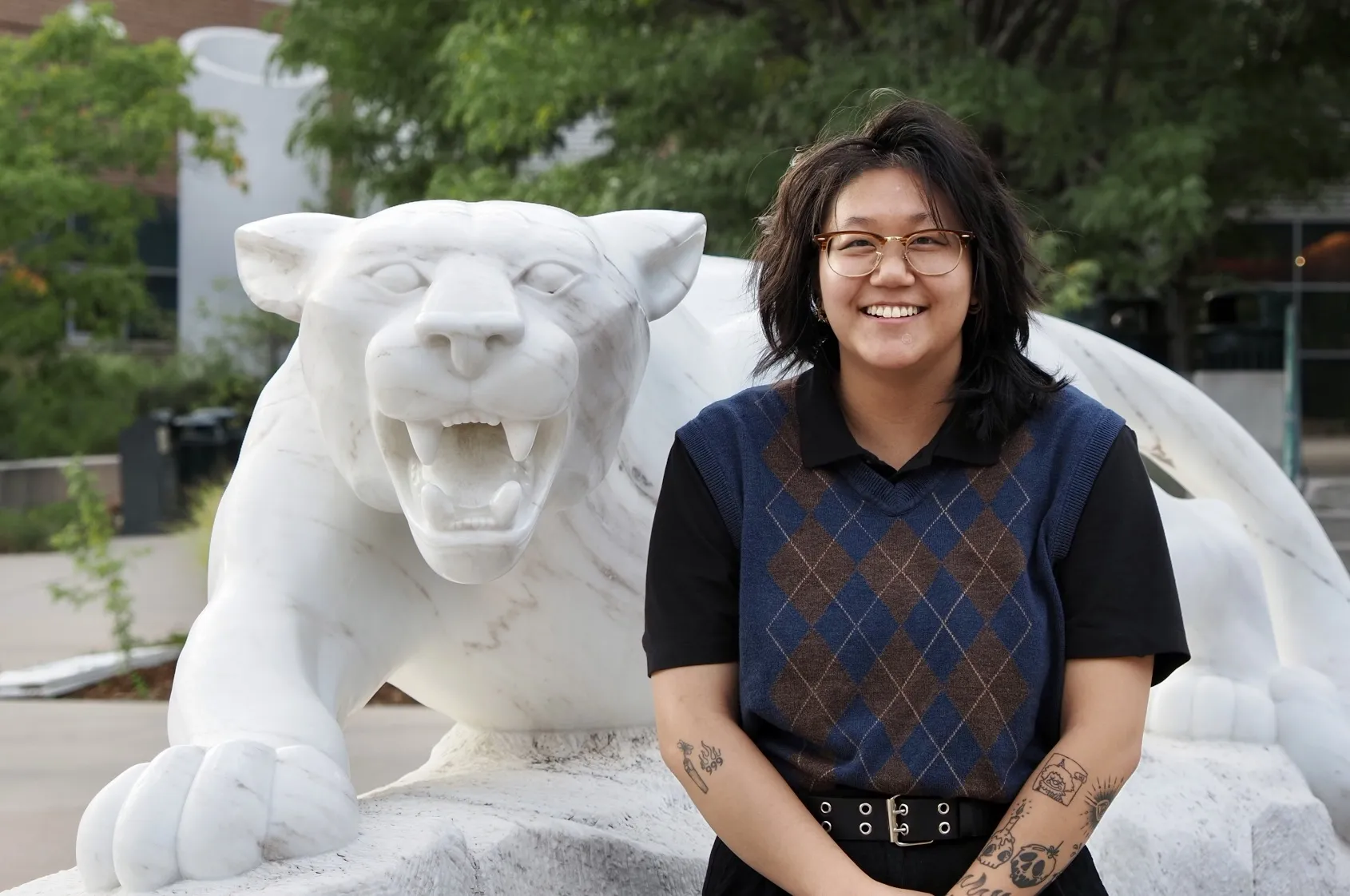 Photo of Jae Brown posing by the Mountain Lion Statue